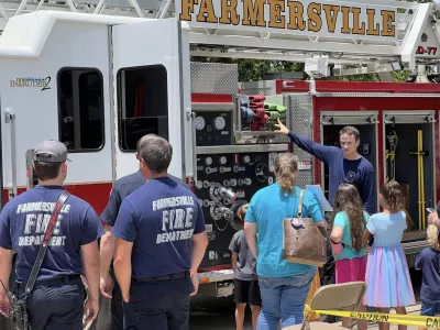 Adults and children standing next to Fire truck