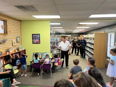 Fire Chief reading a book to kids