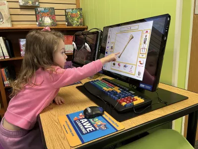 Child playing on the library children's learning computer station