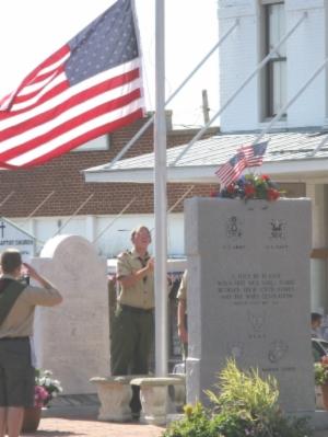 people speaking in front of an American flag