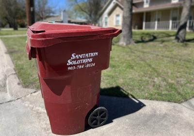 Photo of Sanitations Solutions red polycart bin